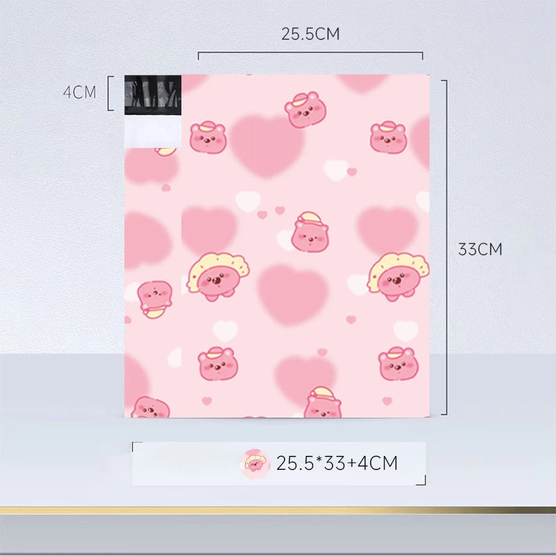 Sacs d'envoi à scellement automatique avec motif cœur rose, dimensions de 4cm et longueur de 25,5cm.