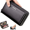 A hand is opening a black leather long zipper wallet clutch to show its interior.