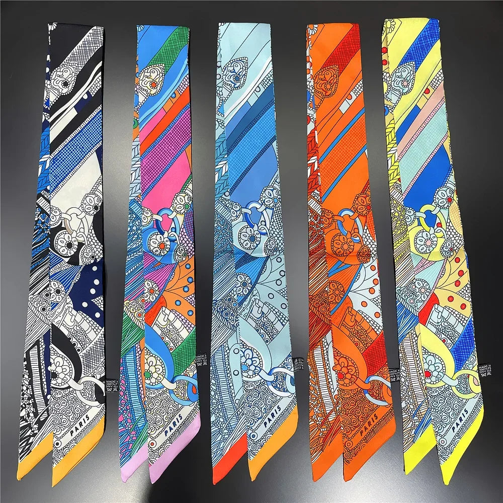 A collection of nine silk twill ribbon scarves featuring various patterns and colors for hair and bag accessories.