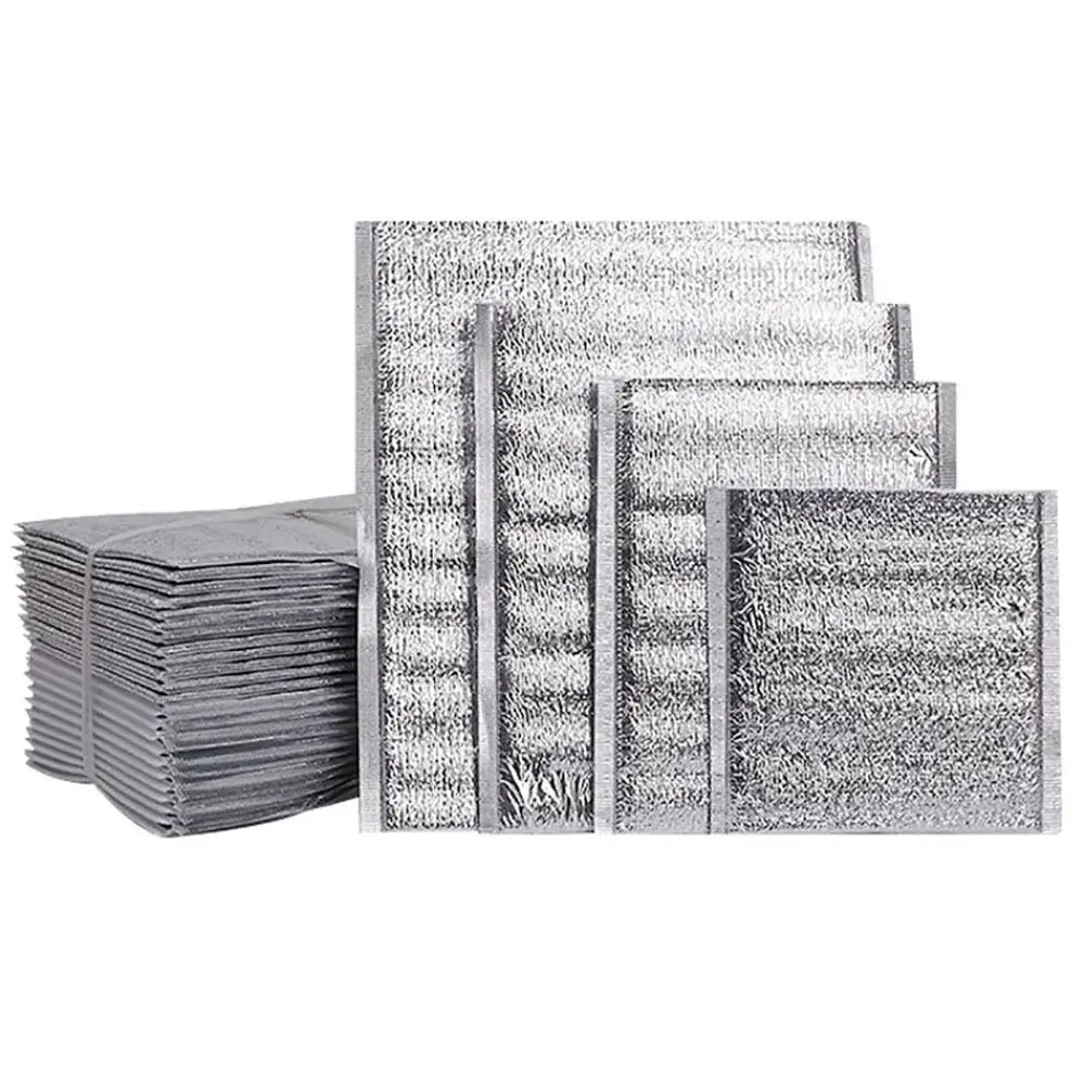 Stack of silver insulated thermal food delivery bags with aluminum foil lining
