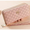 A light pink faux leather double zipper wallet with a gold logo and a matching strap is shown being held by a hand.