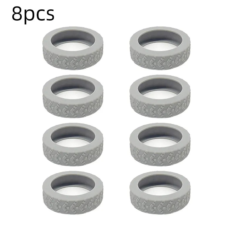 A set of eight gray silicone luggage wheel protection rings.