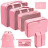 A set of pink fabric storage organizers including rectangular boxes and a drawstring pouch.