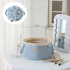 Light blue instant-open flat lay makeup organizer bag sitting on a white table with brushes nearby.