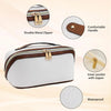 A white cosmetic organizer bag with brown trim and a gold metal zipper, showing features like a double zipper, comfortable ha