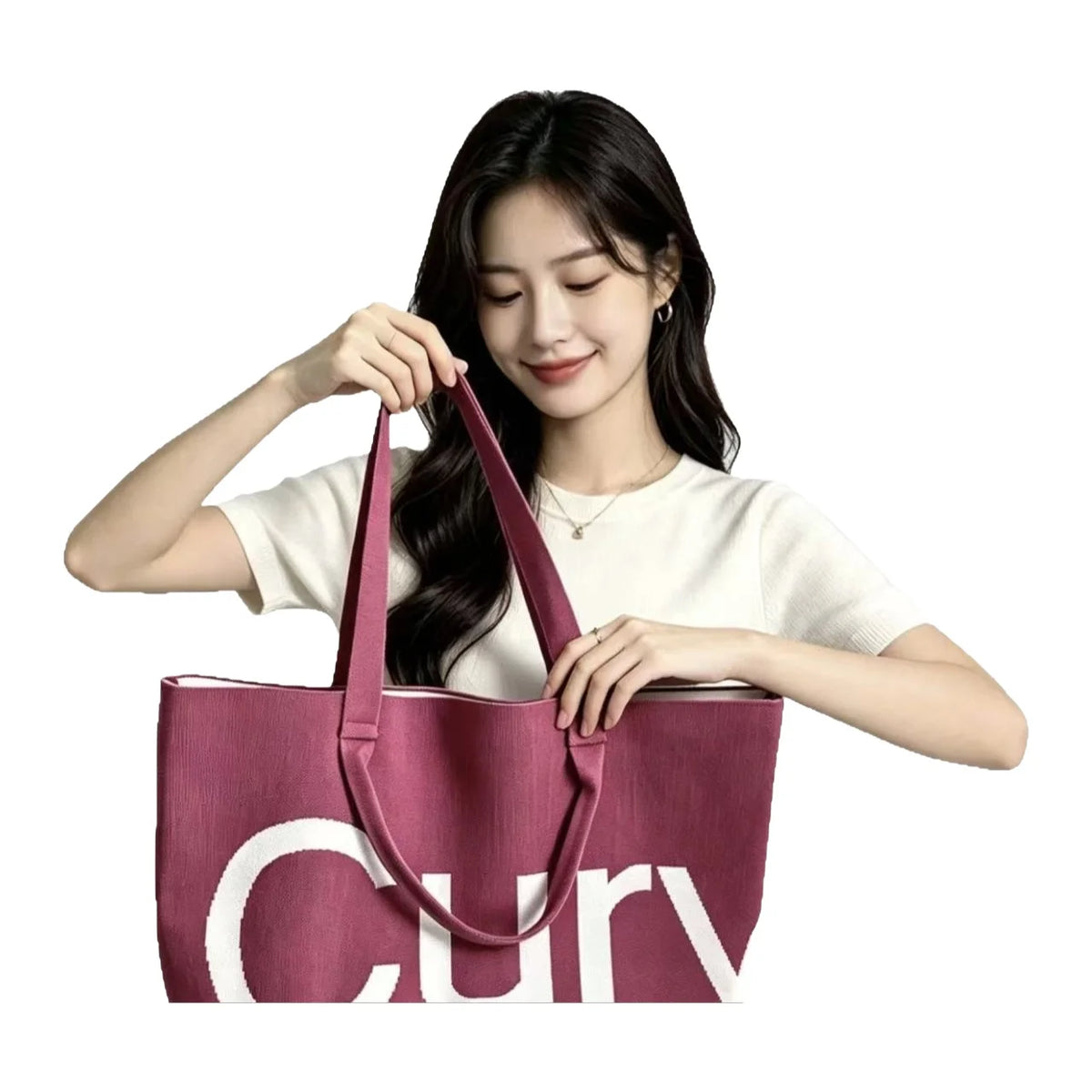 A woman holds a pink knitted large tote bag with a white logo on it.