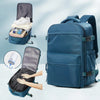 A deep blue expandable vacuum compression travel backpack shown with accessories and a hand demonstrating its features.
