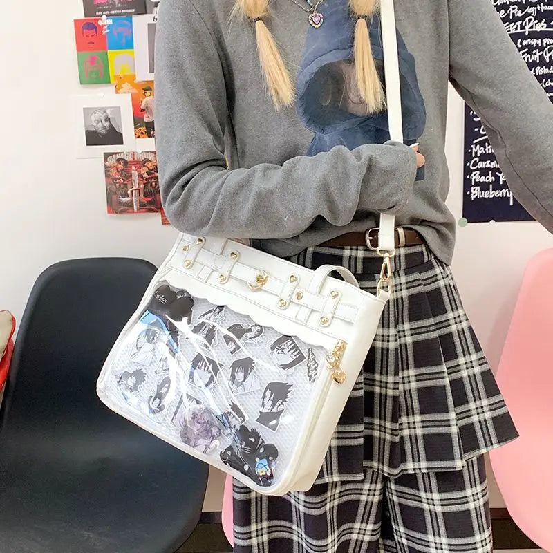 A person is holding a white Y2K punk goth crossbody bag against a background of a gray sweater and plaid skirt.