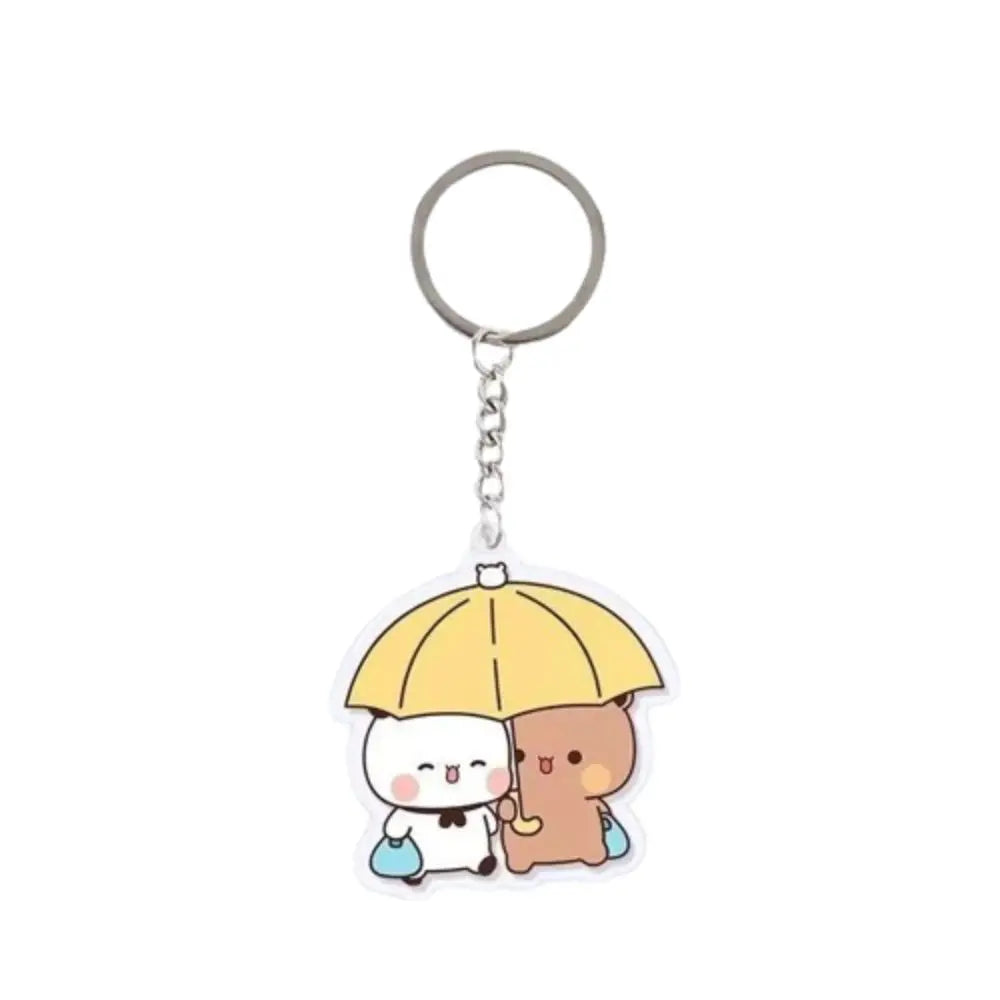A yellow umbrella charm featuring two cute cartoon characters, Bubu and Dudu, on a clear acrylic keychain.