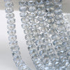 Close-up of clear faceted crystal glass beads in a wheel shape strung together for jewelry making