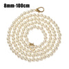 A strand of small, round white pearls on a gold-toned strap.