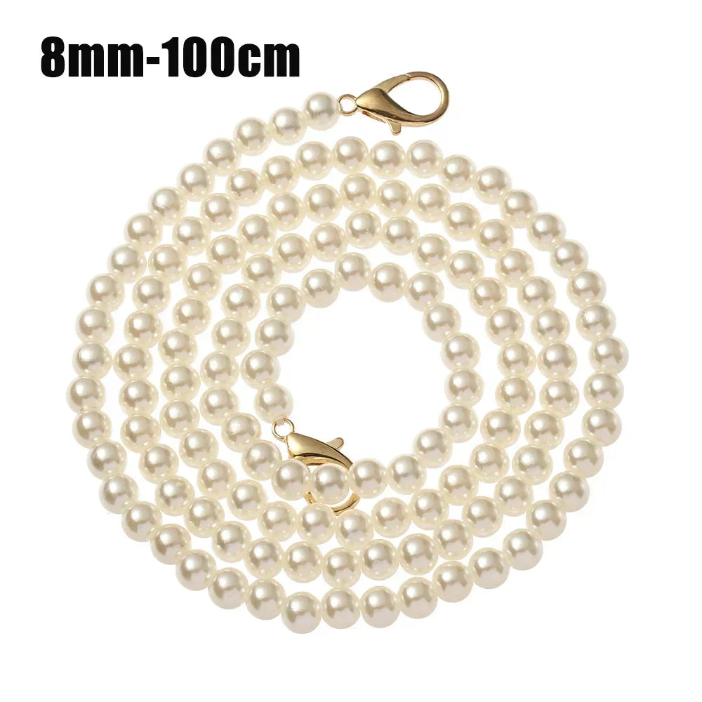 A strand of small, round white pearls on a gold-toned strap.