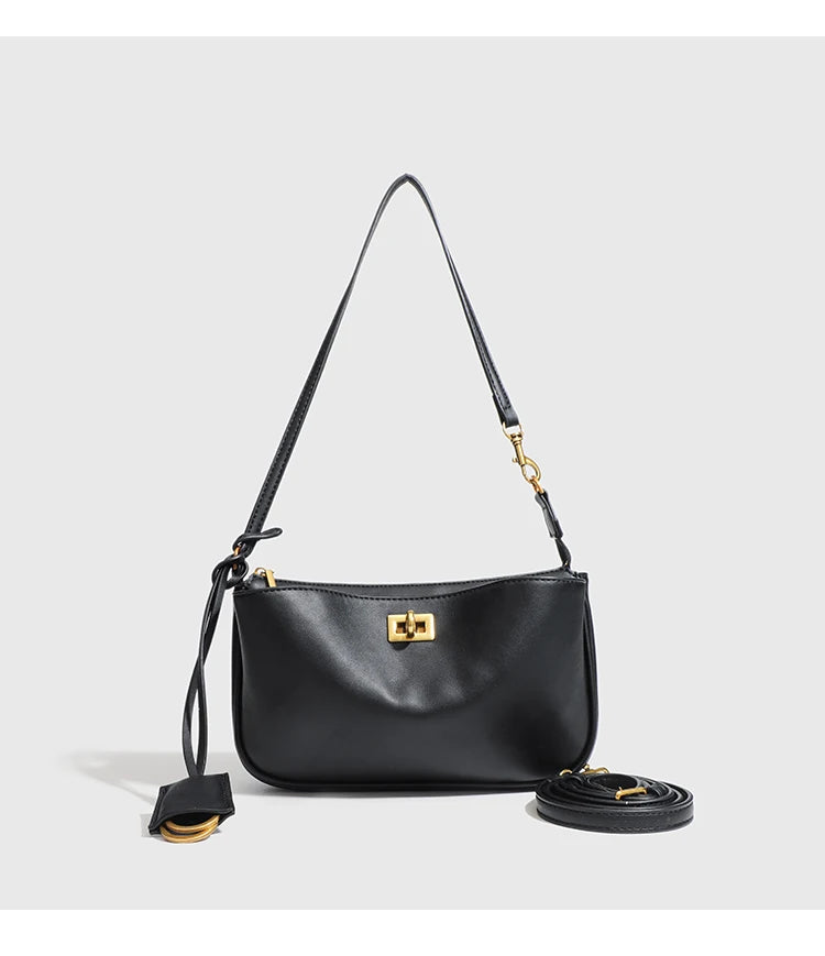 A black split leather shoulder tote bag with gold hardware shown against a light gray background.