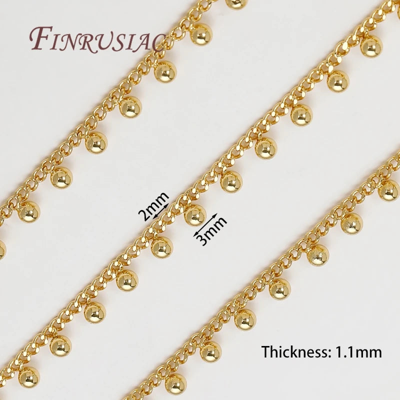 Gold plated jewelry chains with round beads shown in close-up detail