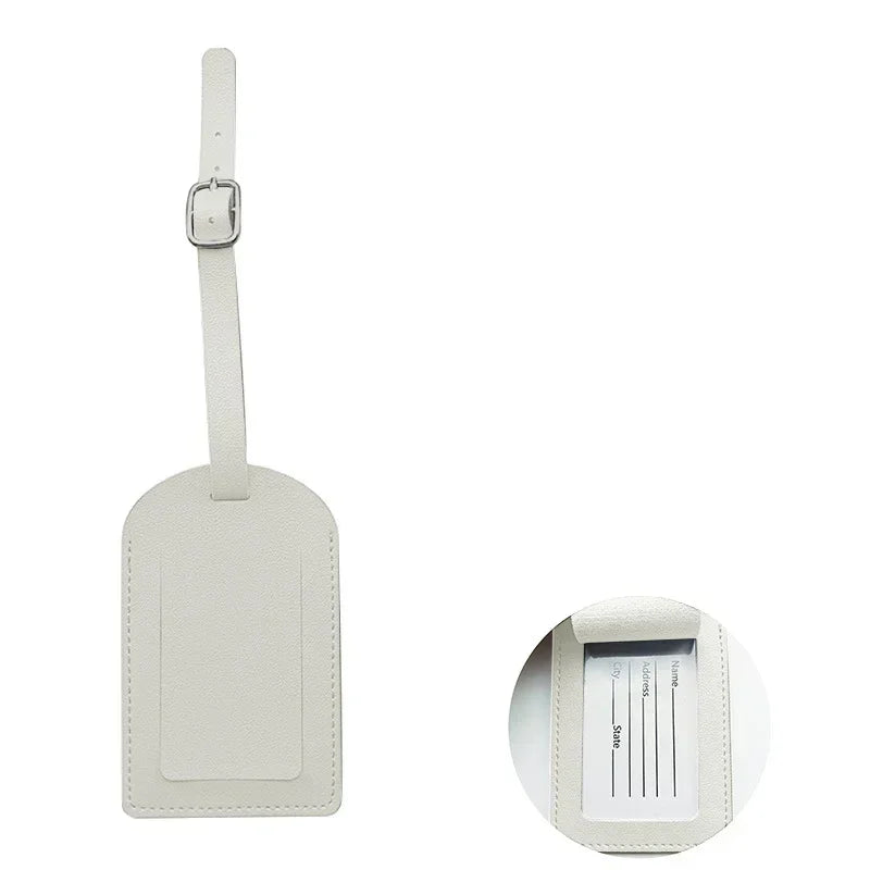 A rectangular light beige PU leather luggage tag with a metal clip attached.