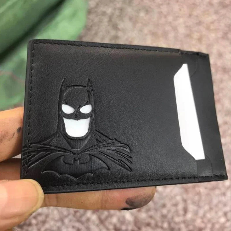 A black leather card holder featuring a silver Bat-Signal emblem on the front.