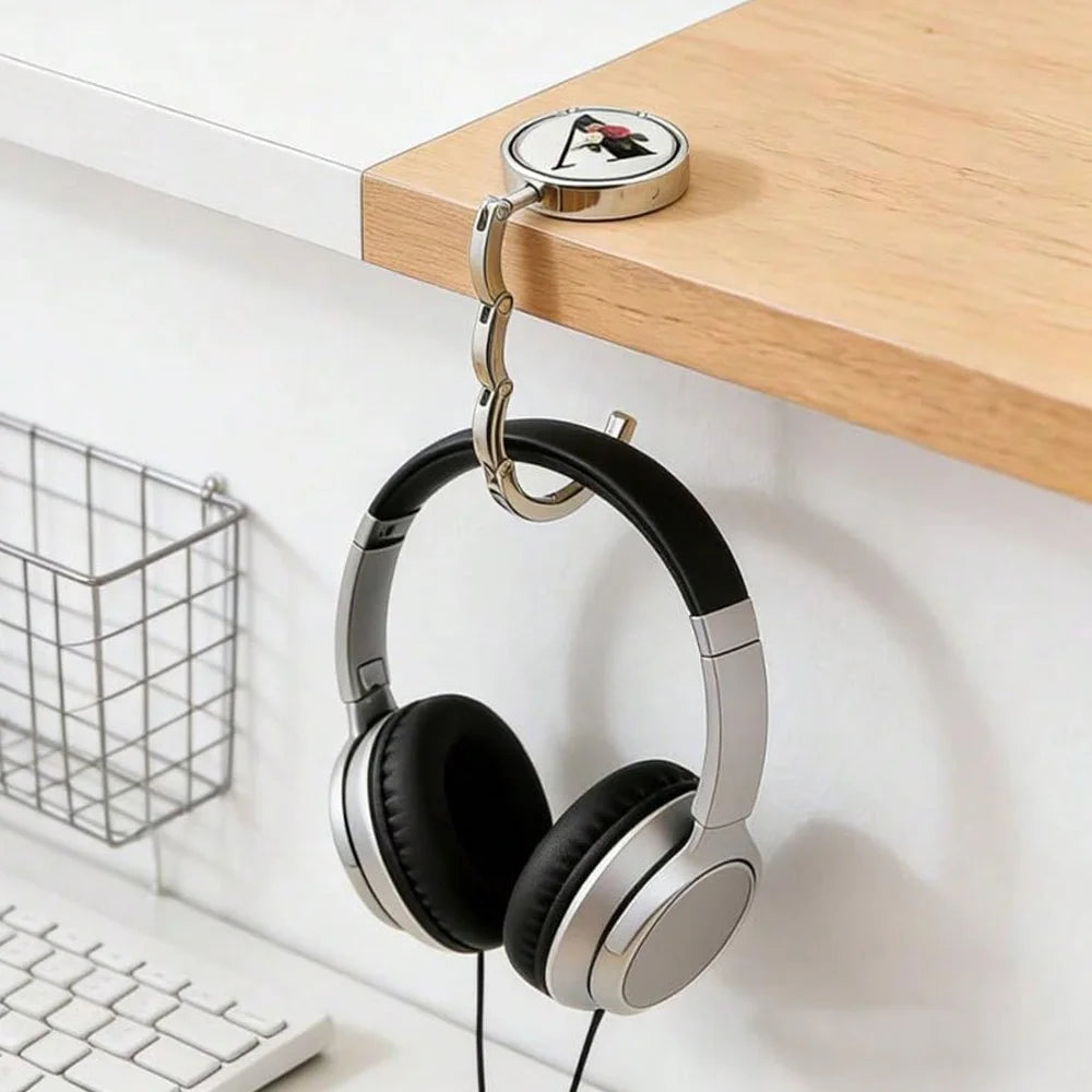 Silver headphones hanging from a wooden shelf hook with a circular plate.