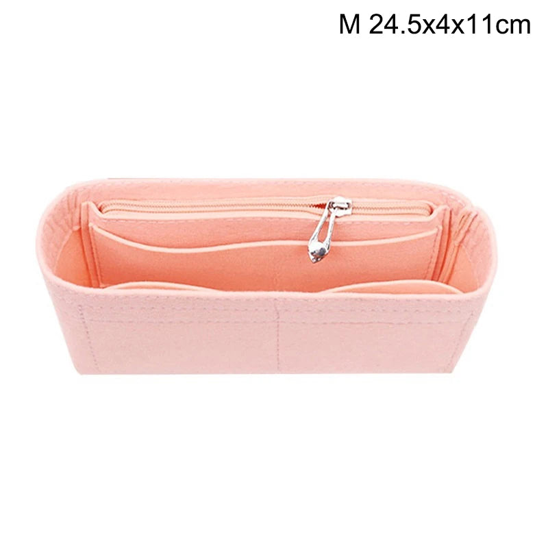 A pink felt bag insert organizer with a zipper closure.