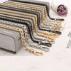 A collection of stainless steel diamond-cut curb chain bag straps in various finishes and lengths.