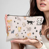 A hand holds a light pink cartoon cat cosmetic pouch for makeup or travel.