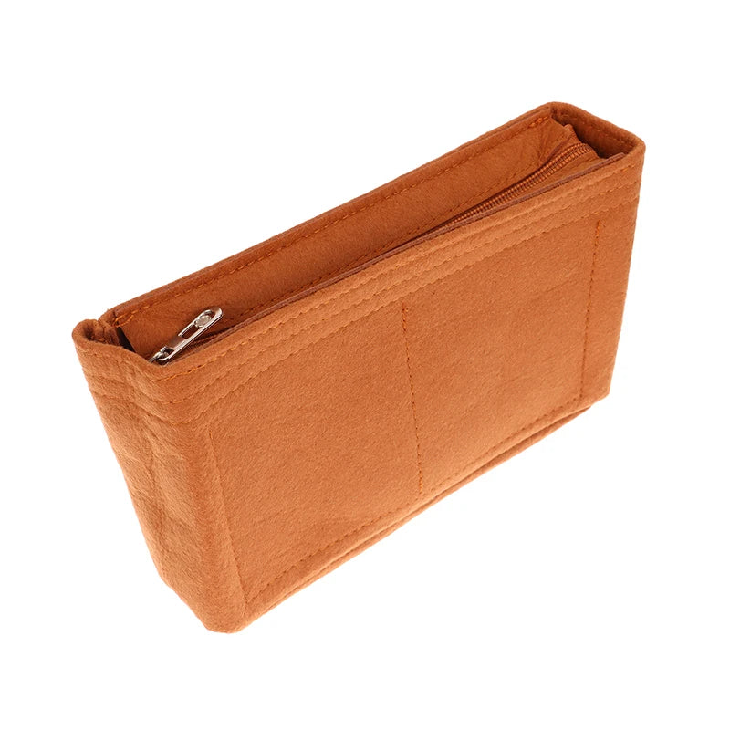 A tan felt cosmetic bag insert organizer with a zippered closure.