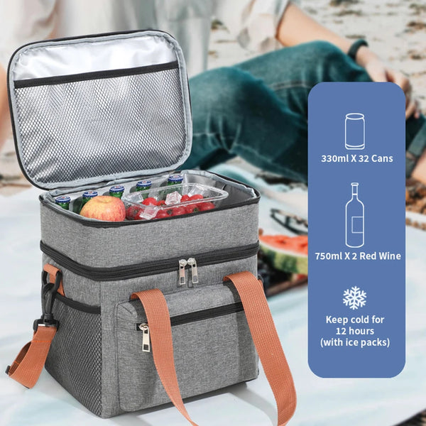 A gray thermal insulated lunch tote bag is open, showing a compartment filled with fruit and a bottle of red wine.