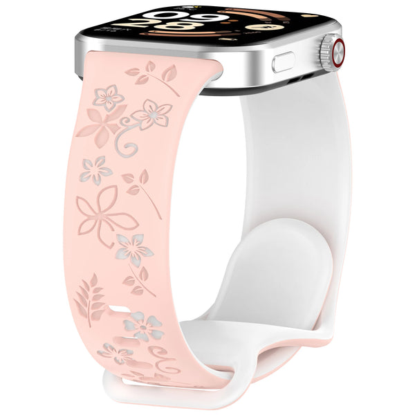A white silicone strap with a pink floral pattern is shown attached to an Apple Watch.