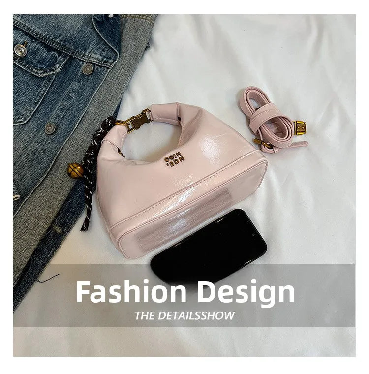 A pink retro PU leather shoulder bag is displayed next to a black accessory on a white background.
