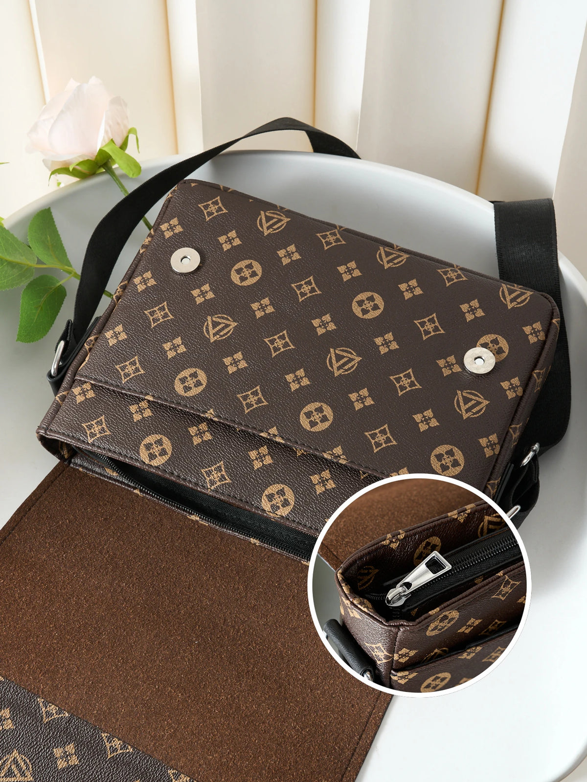 A brown patterned men's casual crossbody bag with a flap design resting on a white surface.