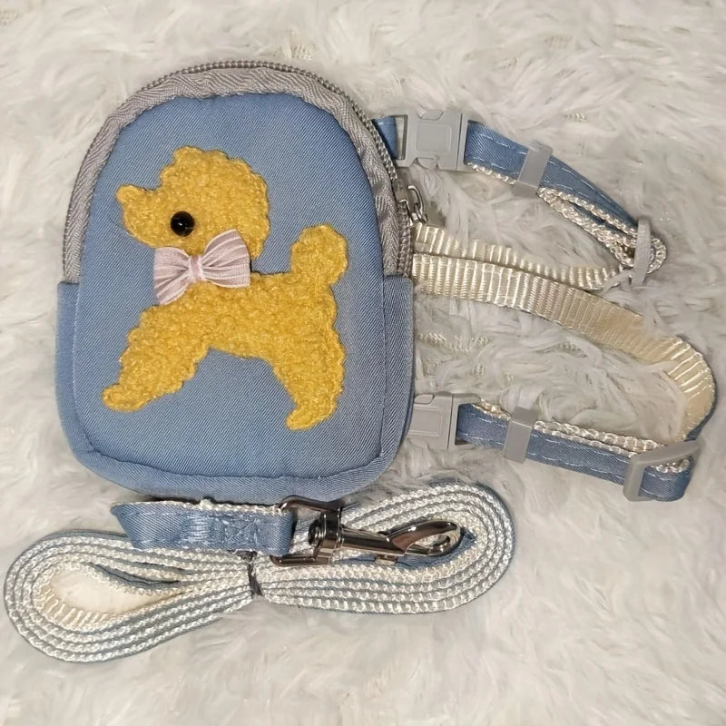 Light blue dog vest with a yellow dog silhouette and attached leash and collar