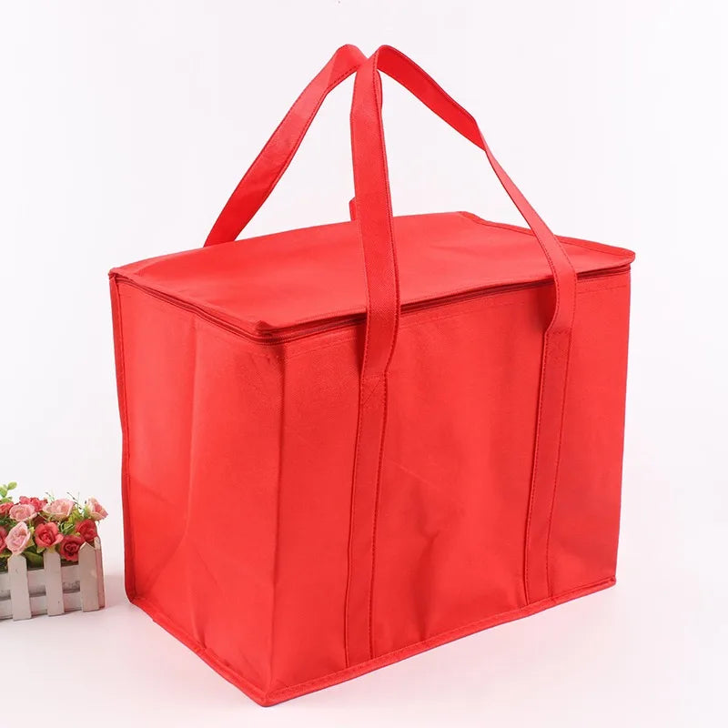 A bright red foldable insulated grocery and food cooler bag with handles.