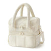 A cream-colored insulated quilted lunch bag with carrying handles and zipper details.