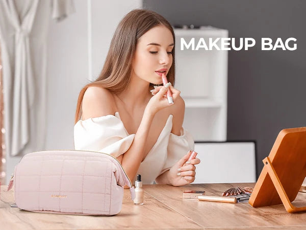 A woman holds a pink padded makeup bag in a natural light setting.