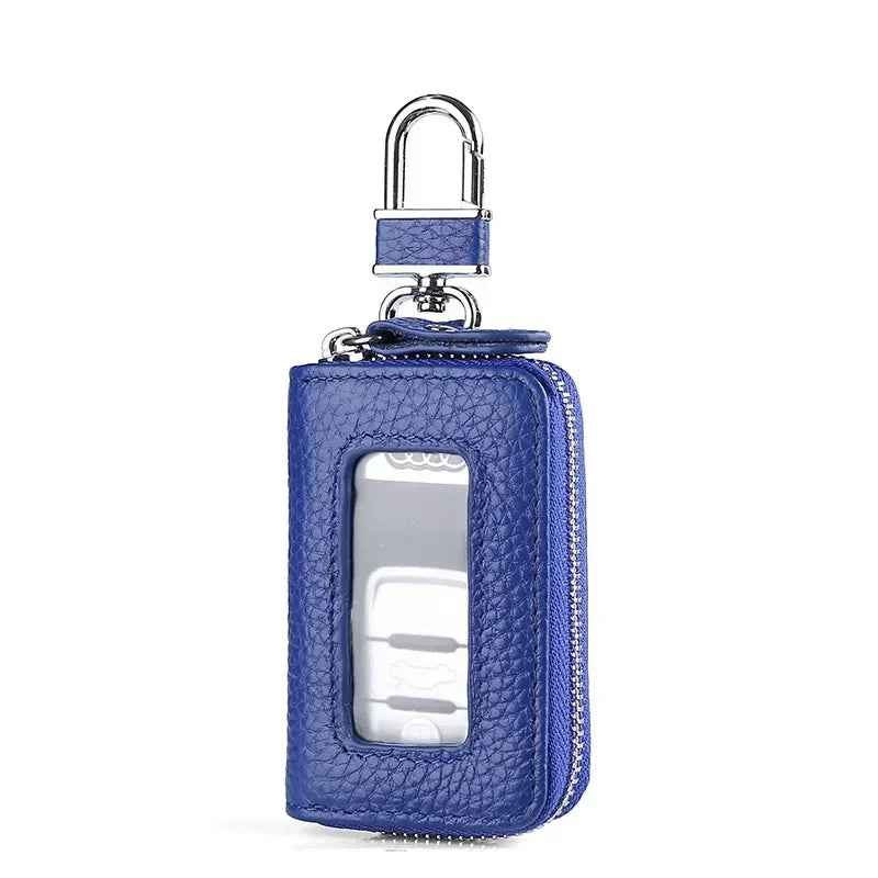A dark blue leather car key case with a silver padlock and a transparent window.