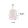 A clear display case framed with pink lace and featuring angel wings, suspended by a star charm.