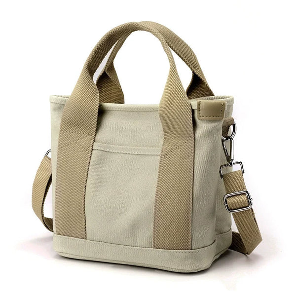 A beige canvas crossbody bag with adjustable straps and multiple pockets.