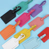 A collection of colorful PU leather luggage tags in various shades including black, pink, purple, orange, yellow, and red.