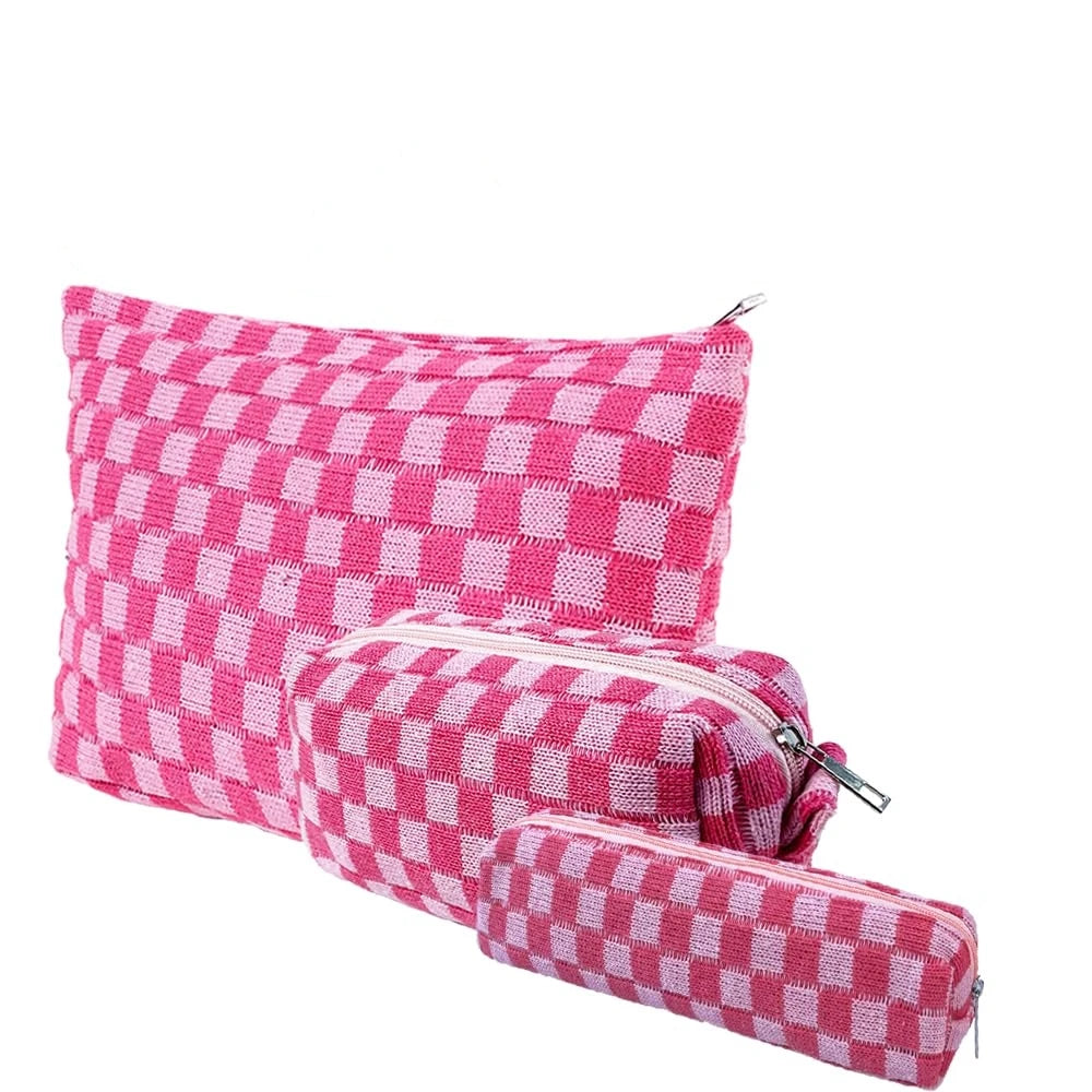A pink and white checkered makeup bag set with a zipper closure.