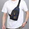 A man wearing a white t-shirt holds a navy blue compact oxford crossbody sling bag.