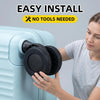 A woman is easily installing a set of black travel luggage wheel protectors onto a light blue piece of luggage.