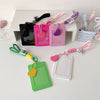 A collection of pink, green, and purple PU credit card and ID holder keychains with various colored cord lanyards.