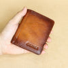 A hand holds a brown genuine leather bi-fold wallet with the name CIEPHIA embossed on it.