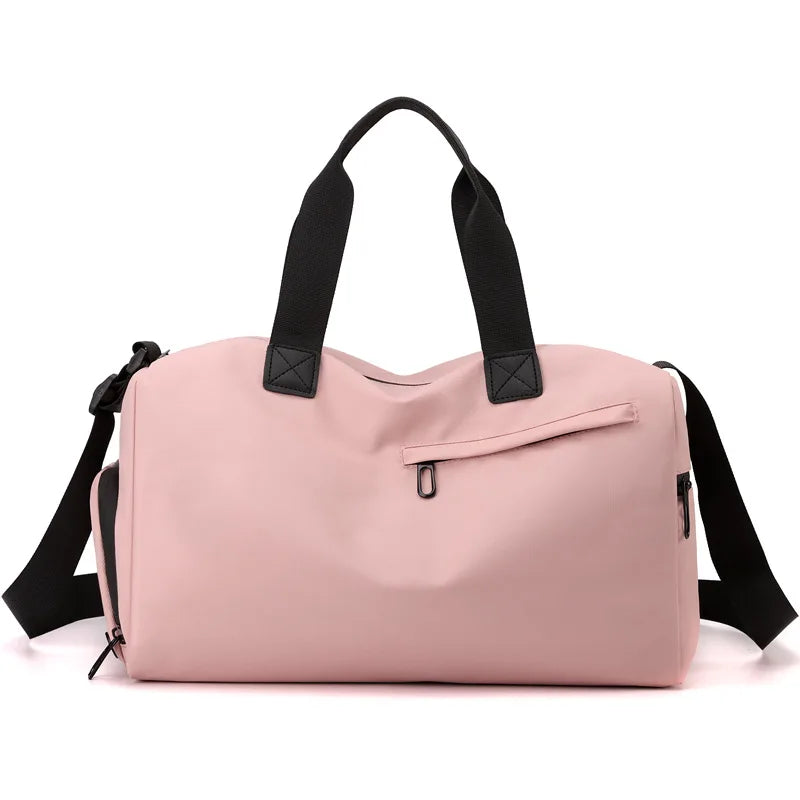 A pink waterproof travel duffle bag with black straps and a separate shoe compartment.