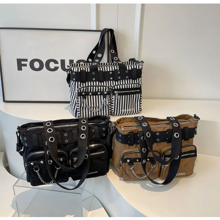A display of black and white patterned nylon shoulder bags featuring metal chains and rivets.