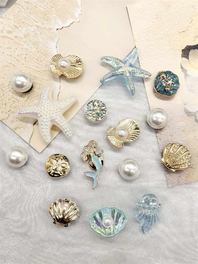 A collection of sea-themed jewelry charms including starfish, conch shells, and pearl accents on a light background.
