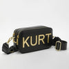 Black leather pouch bag with gold lettering and a black strap