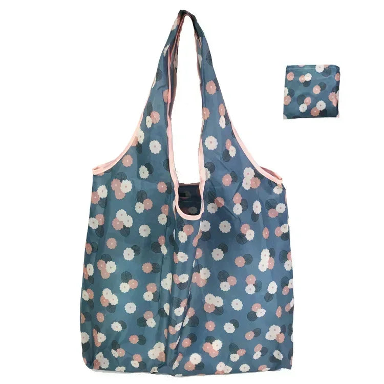 A light blue patterned reusable fashion shopping tote bag shown in a vertical orientation.