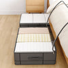 A foldable under-bed storage box with a window featuring striped bedding and a wooden nightstand.