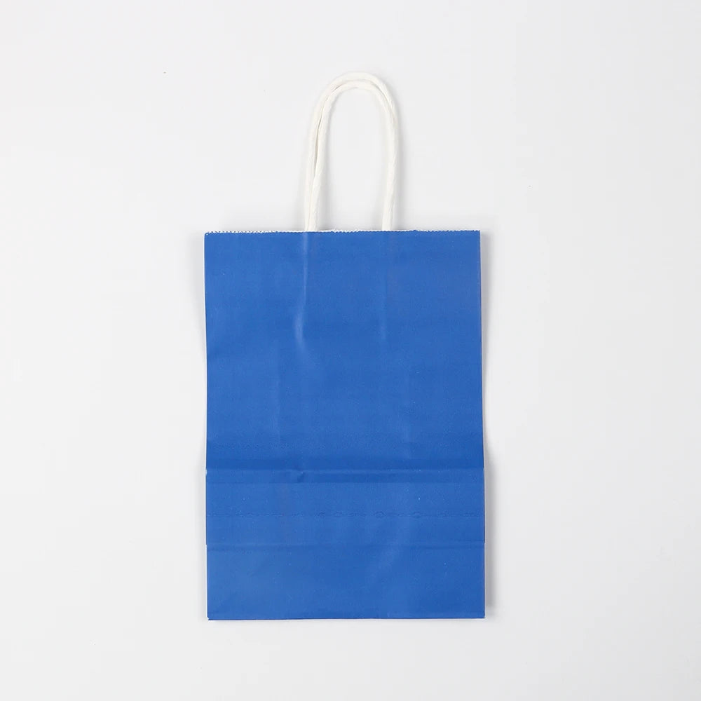 A plain blue reusable kraft paper gift bag with white handles.