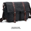 A dark gray canvas messenger bag with brown leather accents shown from the front.